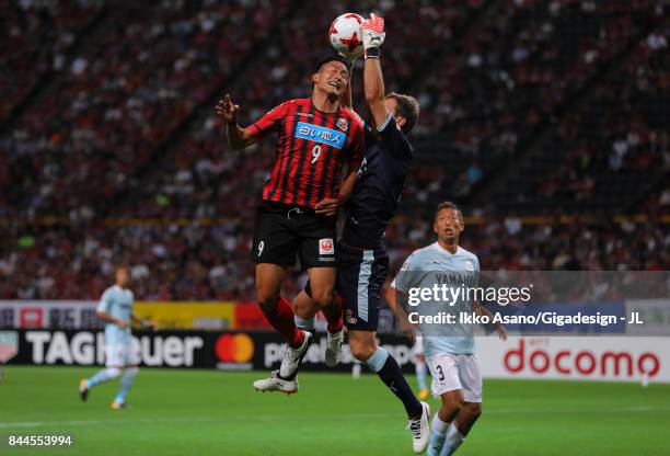 Ken Tokura of Consadole Sapporo and Krzysztof Kaminski of Jubilo Iwata compete for the ball during the J.League J1 match between Consadole Sapporo...