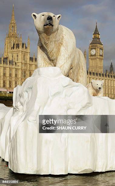 Life-like 16ft high sculpture of an iceberg featuring a stranded polar bear and its cub is pictured on the River Thames in London, on January 26,...