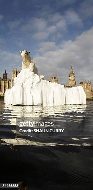 Life-like 16ft high sculpture of an iceberg featuring a stranded polar bear and its cub is pictured on the River Thames in London, on January 26,...