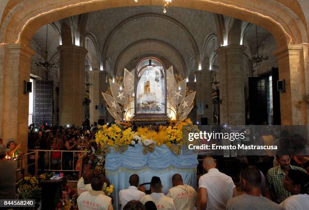 Believers gather to watch as the statue of Cuba's Patron Saint Virgen de la Caridad de Cobre , on September 09, 2017 in Havana, Cuba.