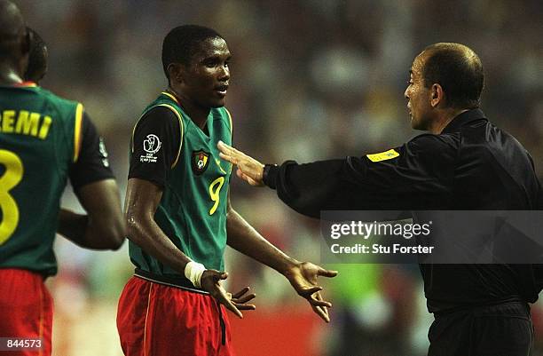 Referee Antonio Lopez Nieto gives a lecture to Samuel Eto'o of Cameroon during the FIFA World Cup Finals 2002 Group E match between Germany and...