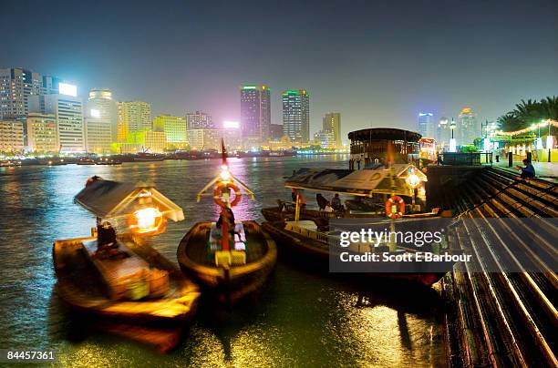 dubai creek skyline and abras - dubai creek stock pictures, royalty-free photos & images