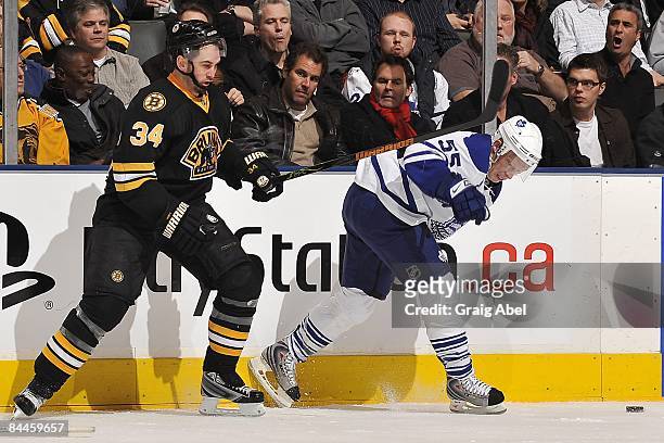 Jason Blake of the Toronto Maple Leafs battles for the puck with Shane Hnidy of the Boston Bruins during game action on January 21, 2009 at the Air...