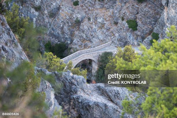 The Devil's Bridge passing through the Raganello River in Civita, a small village in Calabria, southern Italy.