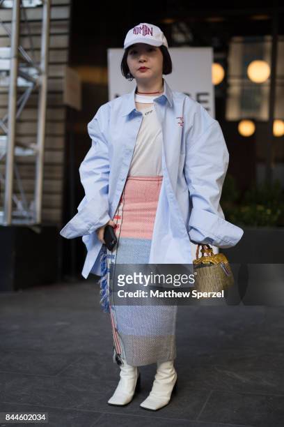 Serian Heu is seen attending Monse during New York Fashion Week wearing a pastel blue coat with white hat on September 8, 2017 in New York City.