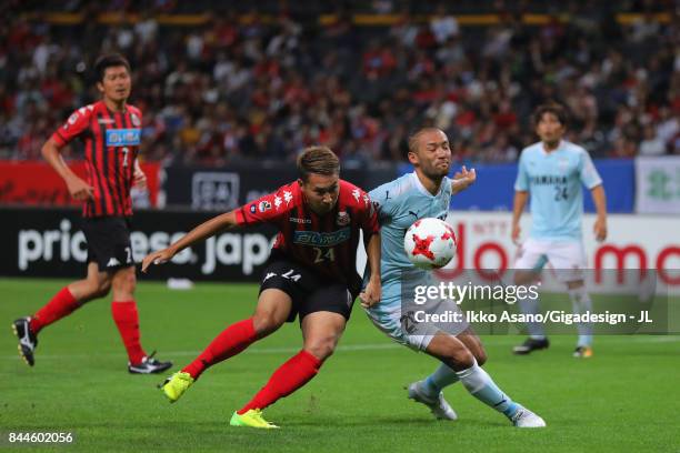 Akito Fukumori of Consadole Sapporo and Kengo Kawamata of Jubilo Iwata compete for the ball during the J.League J1 match between Consadole Sapporo...