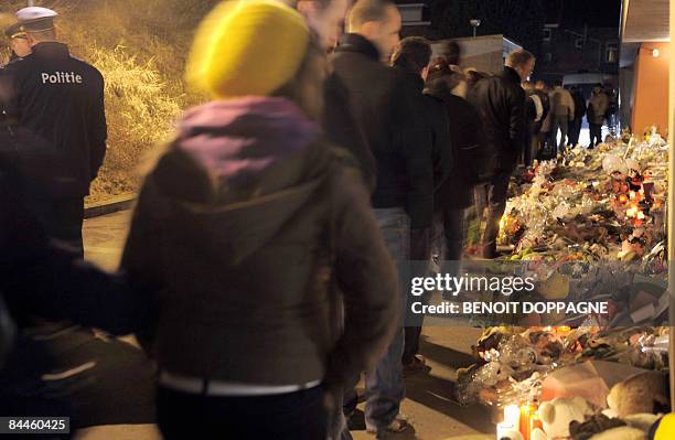 People gather to commemorate the victims of a knife attack at a Belgian creche last week, in Dendermonde on January 26, 2009. In an attack that...