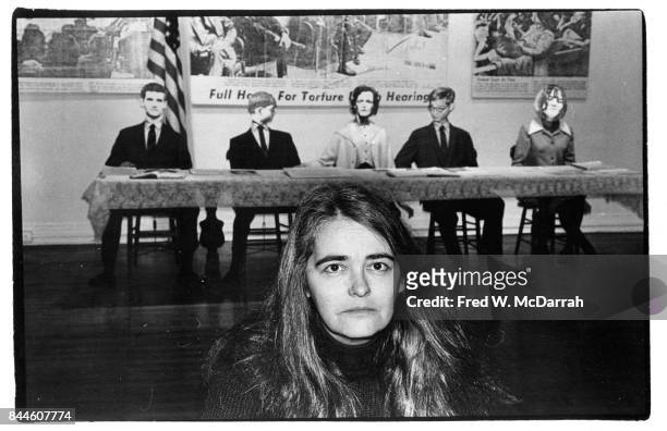 Portrait of American feminist activist, author, and artist Kate Millett as she poses in front of her installation, 'The Trial of Sylvia Likens: A...