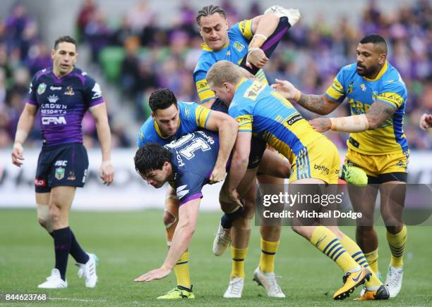 Jordan McLean of the Storm gets tackled during the NRL Qualifying Final match between the Melbourne Storm and the Parramatta Eels at AAMI Park on...