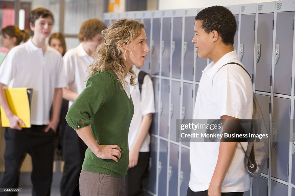 Female teacher reprimanding a male student