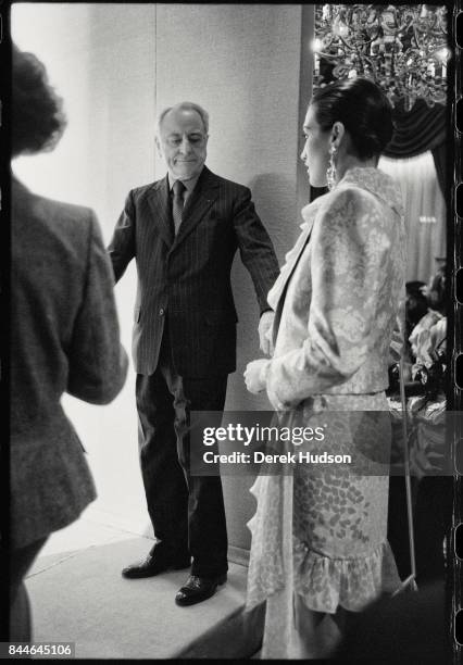 French fashion patron Pierre Berge inspects an unidentified model in the wings at an Yves Saint Laurent haute couture runway show at the Hotel...