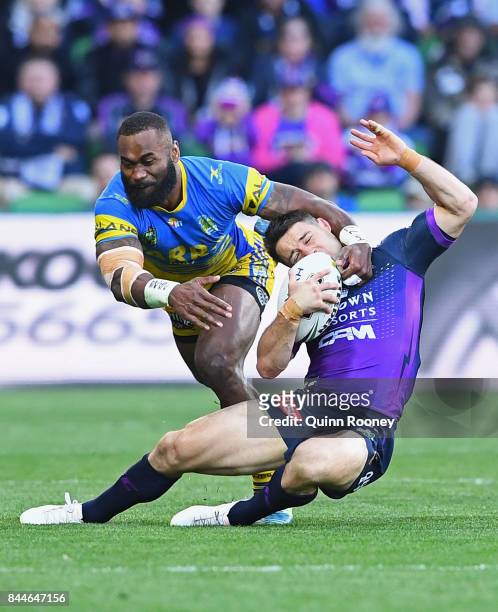 Cooper Cronk of the Storm is tackled by Semi Radradra of the Eels during the NRL Qualifying Final match between the Melbourne Storm and the...
