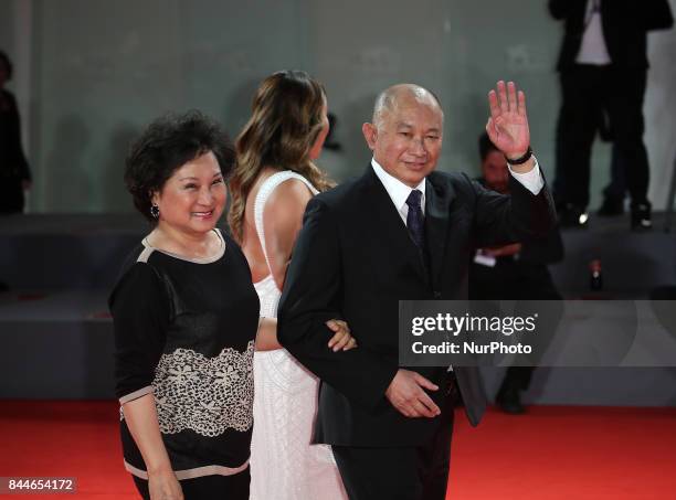 Venice, Italy. 08 September, 2017. Annie Woo Ngau Chun-lung, John Woo and Angeles Woo walk the red carpet ahead of the 'Manhunt ' screening during...