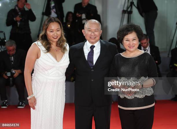 Venice, Italy. 08 September, 2017. Annie Woo Ngau Chun-lung, John Woo and Angeles Woo walk the red carpet ahead of the 'Manhunt ' screening during...