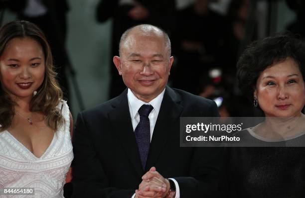 Venice, Italy. 08 September, 2017. Annie Woo Ngau Chun-lung, John Woo and Angeles Woo walk the red carpet ahead of the 'Manhunt ' screening during...