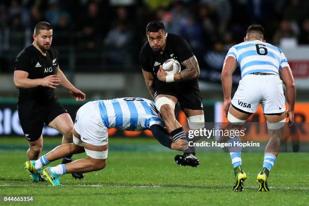 Vaea Fifita of New Zealand is tackled by Benjamin Macome of Argentina during The Rugby Championship match between the New Zealand All Blacks and...