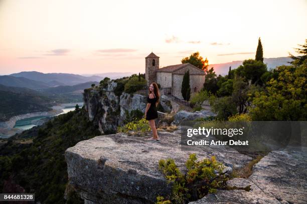 beautiful traveler woman contemplating the view from the stunning siurana town on top of cliff with amazing views during travel vacations in the catalonia region. - vertige photos et images de collection