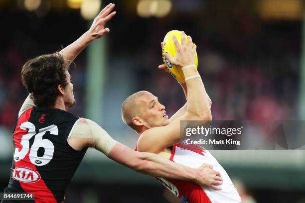 Sam Reid of the Swans is challenged by Michael Hartley of the Bombers during the AFL Second Elimination Final match between the Sydney Swans and the...