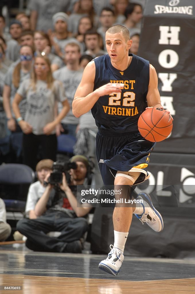 Alex Ruffa Alex Ruoff of the West Virginia Mountaineers dribbles up court during ...