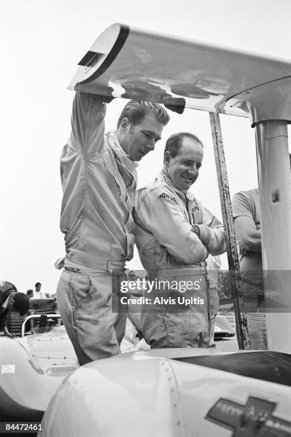 Jim Hall leans on the wing of his Chaparral 2G and chats with Denny Hulme before the Road America CanAm on September 1, 1968 in Elkhart Lake,...