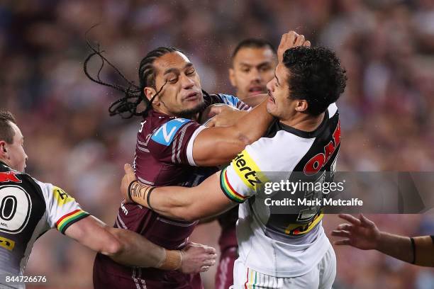 Martin Taupau of the Sea Eagles is tackled by Corey Harawira Naera of the Panthers during the NRL Elimination Final match between the Manly Sea...