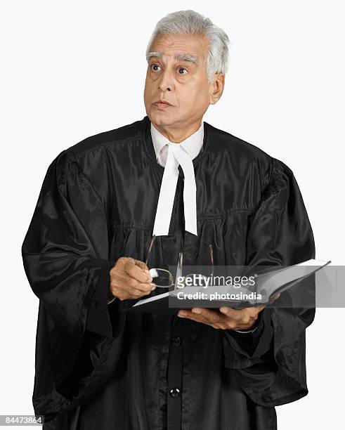 male lawyer holding a book - avocat justice photos et images de collection