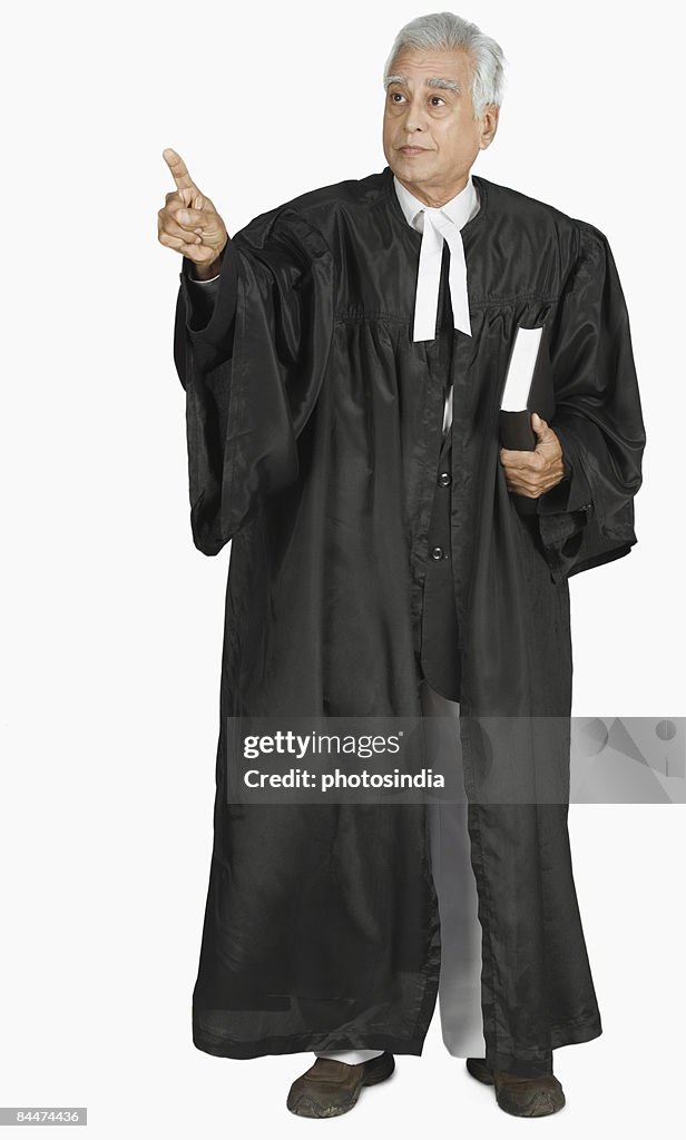 Male lawyer holding a book and pointing