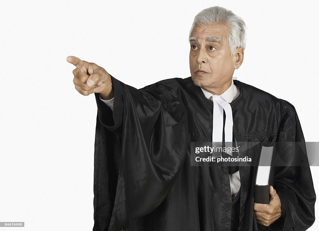 Male lawyer holding a book and pointing