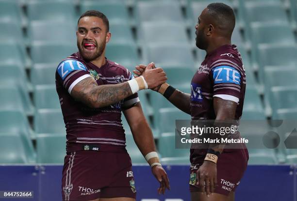 Dylan Walker of the Sea Eagles celebrates scoring a try with team mate Akuila Uate of the Sea Eagles during the NRL Elimination Final match between...