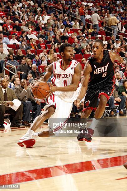 Aaron Brooks of the Houston Rockets drives to the basket past Mario Chalmers of the Miami Heat during the game at Toyota Center on January 17, 2009...