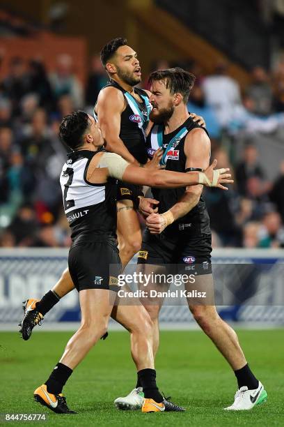 Charlie Dixon of the Power celebrates with Sam Powell-Pepper and Jarman Impey of the Power during the AFL First Elimination Final match between Port...