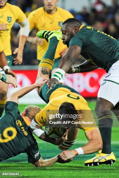 Australia's Sean McMahon dives as he attempts to break a tackle during the Rugby Championship match between Australia and South Africa in Perth on...