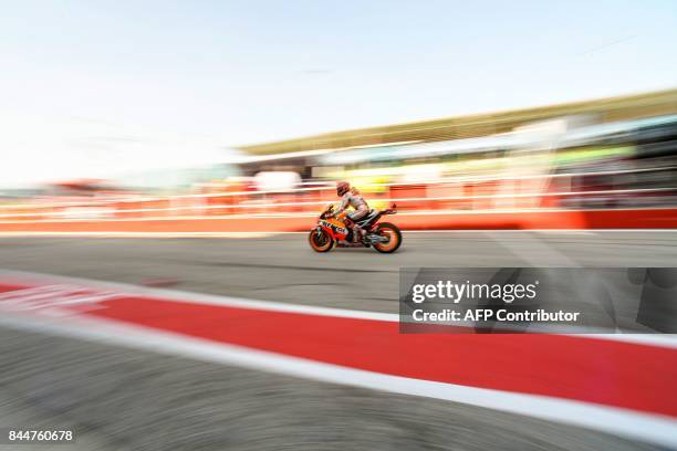 Repsol Honda's Spanish rider Marc Marquez rides his bike out of the pit during a free practice session of the San Marino Moto GP Grand Prix race at...