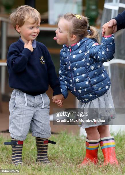 Mia Tindall sticks her tongue out at Charlie Meade as they attend the Whatley Manor Horse Trials at Gatcombe Park on September 8, 2017 in Stroud,...