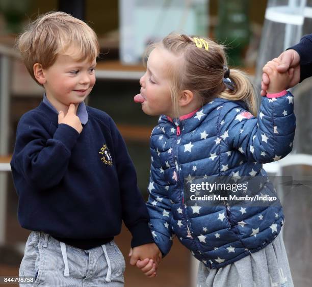 Mia Tindall sticks her tongue out at Charlie Meade as they attend the Whatley Manor Horse Trials at Gatcombe Park on September 8, 2017 in Stroud,...