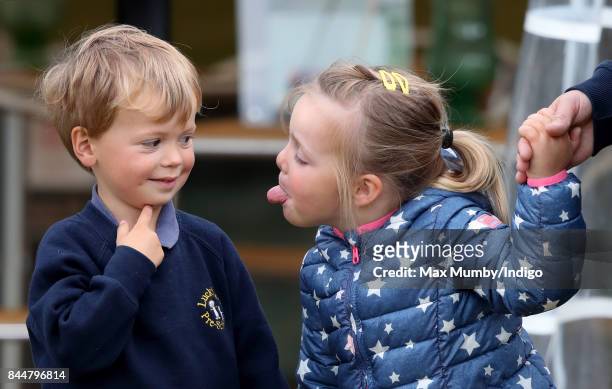 Mia Tindall sticks her tongue out at Charlie Meade as they attend the Whatley Manor Horse Trials at Gatcombe Park on September 8, 2017 in Stroud,...
