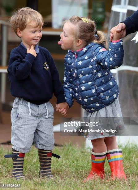 Mia Tindall sticks her tongue out at Charlie Meade as they attend the Whatley Manor Horse Trials at Gatcombe Park on September 8, 2017 in Stroud,...