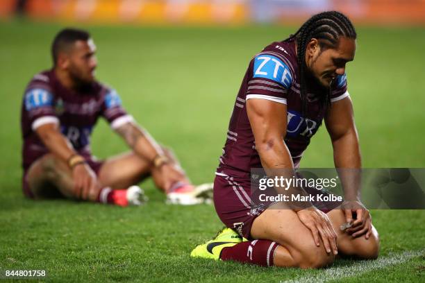 Apisai Koroisau and Martin Taupau of the Sea Eagles look dejected after defeat during the NRL Elimination Final match between the Manly Sea Eagles...