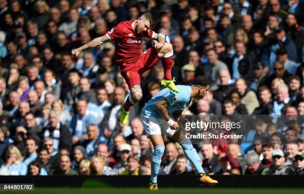 Alberto Moreno of Liverpool and Kyle Walker of Manchester City battle for possession during the Premier League match between Manchester City and...