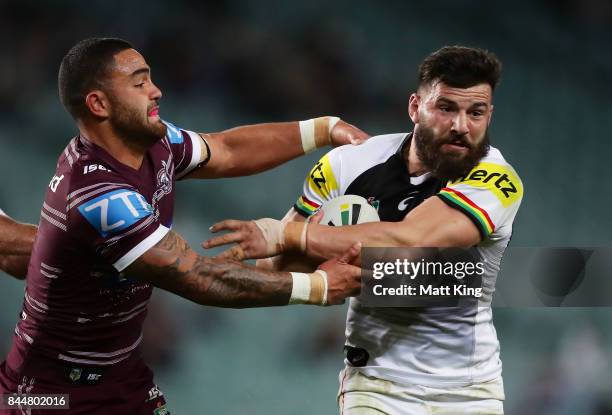 Josh Mansour of the Panthers is tackled by Dylan Walker of the Sea Eagles during the NRL Elimination Final match between the Manly Sea Eagles and the...