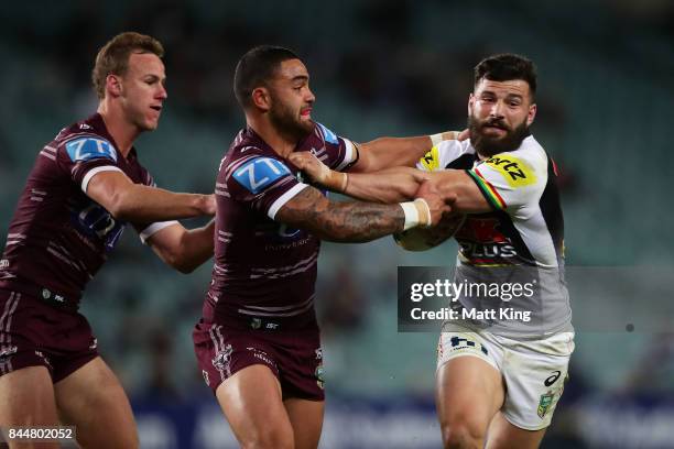 Josh Mansour of the Panthers is tackled by Dylan Walker of the Sea Eagles during the NRL Elimination Final match between the Manly Sea Eagles and the...