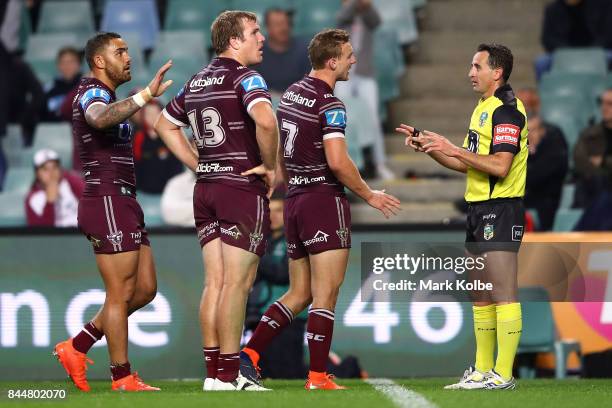 Dylan Walker, Jake Trbojevic and Daly Cherry-Evans of the Sea Eagles argue with referee Gerard Sutton after the try to Tyrone Peachey of the...