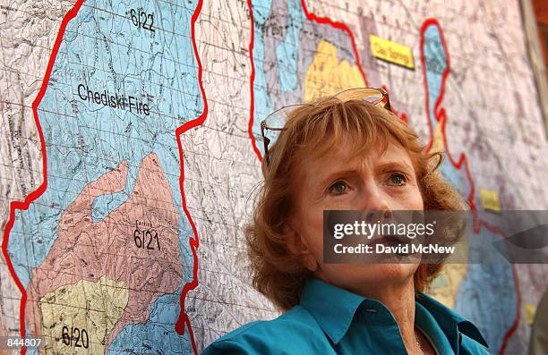 Arizona Governor Jane Dee Hull stands next to a map of the Chediski and Rodeo Fires as they join to become one massive fire, that is threatening the...