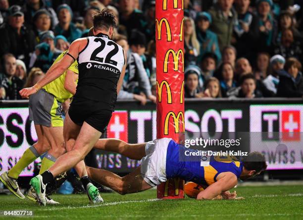 Eric Mackenzie of the Eagles takes the ball over the line as Charlie Dixon of the Power competes for the ball during the AFL First Elimination Final...