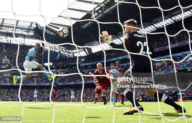 Gabriel Jesus of Manchester City scores his sides second goal past Simon Mignolet of Liverpool during the Premier League match between Manchester...