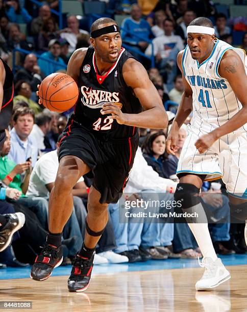 Elton Brand of the Philadelphia 76ers drives by James Posey of the New Orleans Hornets on January 26, 2009 at the New Orleans Arena in New Orleans,...