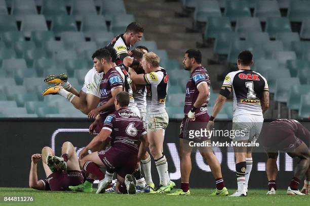 Panthers players celebrate a try by Bryce Cartwright of the Panthers during the NRL Elimination Final match between the Manly Sea Eagles and the...