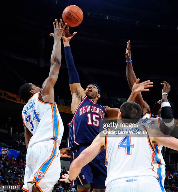 Vince Carter of the New Jersey Nets goes to the basket against Desmond Mason of the Oklahoma City Thunder at the Ford Center on January 26, 2009 in...