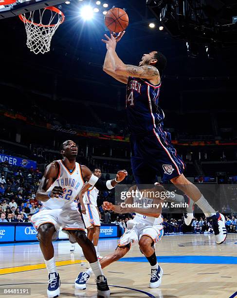 Devin Harris of the New Jersey Nets goes to the basket against Jeff Green of the Oklahoma City Thunder at the Ford Center on January 26, 2009 in...