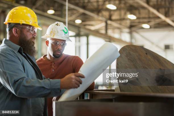 factory workers looking at plans - plus size model male stock pictures, royalty-free photos & images